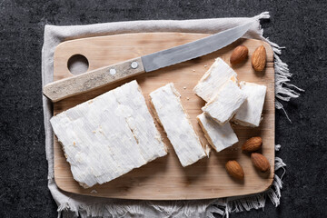 Christmas almond nougat on black slate background. Top view