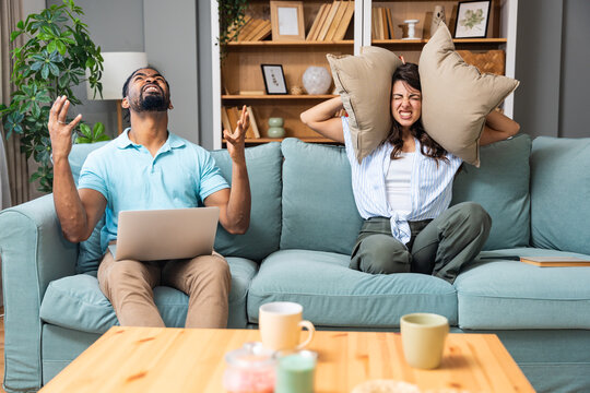 Urban city living issues. Young couple just moved to new apartment having problems with neighbors and low quality noise insulation of construction of the building. Stressed and irritated people.