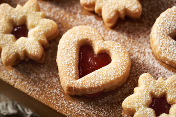 Heart shaped Linzer Christmas cookie filled with delicious strawberry marmalade and dusted with sugar
