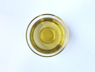 Vegetable oil in bowl isolated on white background. Food ingredient, Flat lay 