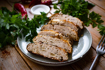 Gefilte fish on a plate on a wooden table. Stuffed fish for lunch. Stuffed carp on a plate on a wooden background. Close-up