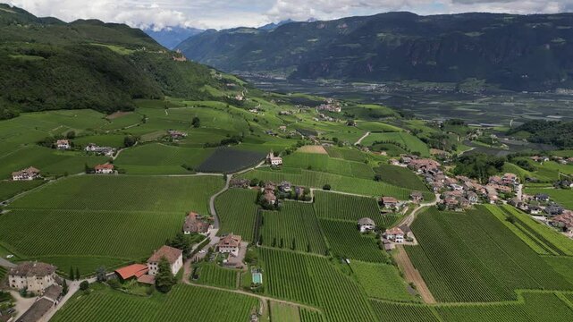 Drone top video of Italian green valley with mountains streets castles in Trentino