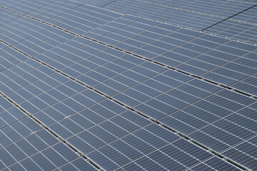 Solar panels, blue solar panels. photovoltaic modules for renewable and alternative electricity energy. Blue sky in background.