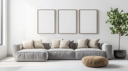 Fototapeta premium A modern living room featuring a spacious gray sofa with cushions, three empty frames on the wall, and a decorative plant in a minimalist setup.