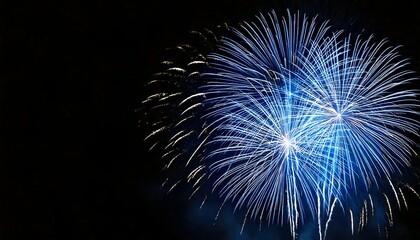 beautiful silver and blue fireworks on black background with copyspace for holiday use