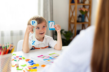 Boy learning letters in classroom setting