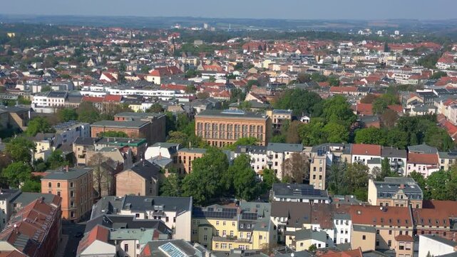 halle saale with the red brick building of the library surrounded by trees and houses, in germany. Fabulous aerial view flight drone shot footage from above