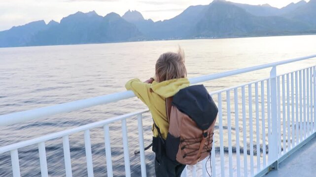 People, enjoying ferry ride between Bodo and Lofoten Moskenesoya summertime, child and adults on a ferry