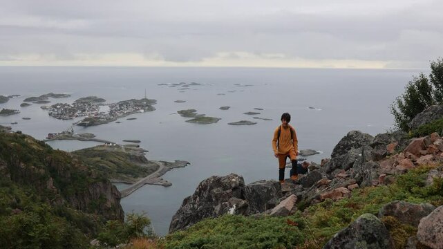 Children and adults, happy family with dog, climbing Festvagtinden via Heiavatnet trail in Norway