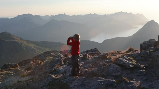 Children and adults, family with dog, hiking Grytetippen trail in Senja, Lofoten on a sunny hot summer day