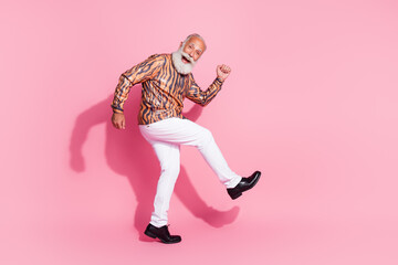 Fototapeta premium Photo of excited old man walking wear shiny shirt pants isolated pastel color background