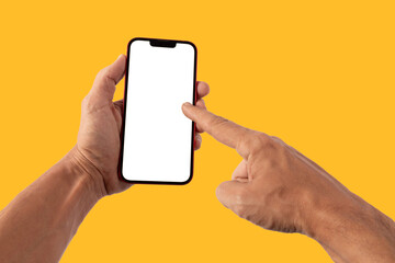 Male hands holding a red smartphone, pointing gesture, on yellow background mockup