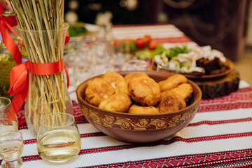 Traditional Ukrainian celebration table with homemade fried pastries, decor, and national cuisine