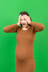 Fototapeta premium Beautiful young pregnant woman feeling head ache on colored background isolated. Stressed pregnant woman or mother problems