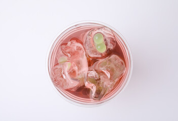 Tasty bubble tea in plastic cup on white background, top view