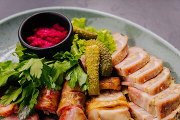 Appetizing meat platter with pickles, herbs and beetroot dip, perfect for traditional gourmet dining