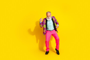 Full body photo of nice senior male have fun disco wear trendy colorful pink fancy outfit isolated on yellow color background