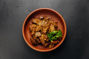 Top view of homemade roasted meat with onions, herbs. Perfect for food blogs, cookbooks, and menus