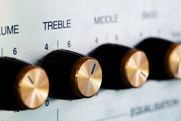 Close-up of Audio Control Knobs on Amplifier Panel