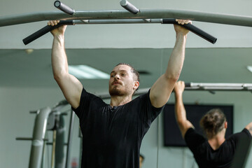 Man workout on pressing machine in gym calories burn lose weight for health. Strong sportsman...