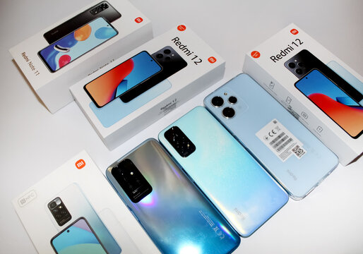 Kyiv, Ukraine. 10.10.2024:Display of multiple smartphone models including Redmi 12 and Redmi Note 11 along with their packaging on a table. Stock editorial photo.