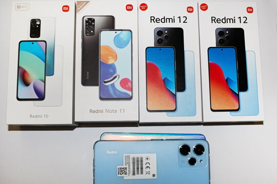 Kyiv, Ukraine. 10.10.2024:Mi smartphones displayed in attractive packaging showcasing models including Redmi 10, Note 11, and Redmi 12 on a table. Stock editorial photo.