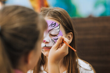 Professional make-up artist, female artist draws with pencil, brush, watercolors, makes face...