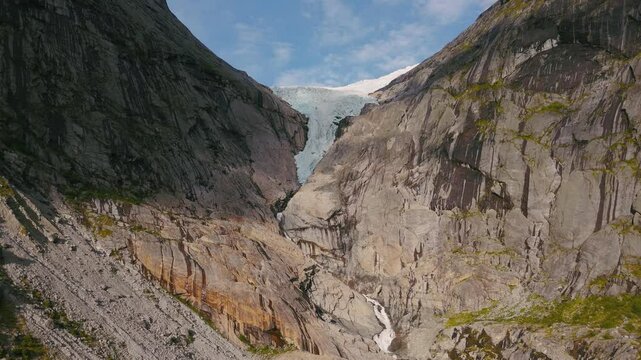 Approaching Briksdalsbreen Glacier in Norway, Scandinavia with thick ice. Epic mountain nature aerial.