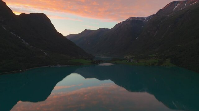 Oldevatnet lake sunset sky with water reflection. Briksdalsbreen glacier. Norway Scandinavia nature