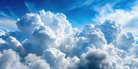 Naklejka premium A vast expanse of fluffy white clouds, clustered together against a bright blue sky, creating a stunning natural masterpiece.