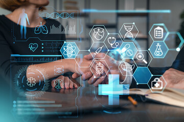 Healthcare professionals shaking hands with digital medical icons overlaying.
