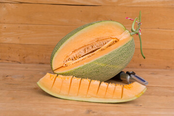 split the orange melon on wood plate