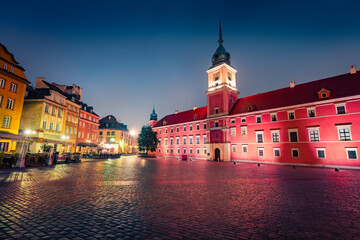 Illuminated night view of Royal Castle in Warsaw and empty Castle Square. Fantastic autumn cityscape of capital of Poland - Warsaw city, Europe. Traveling concept background.