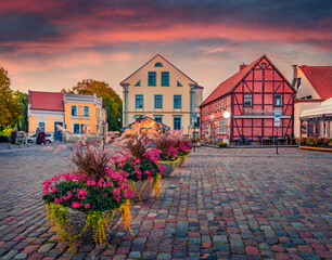 Splendid summer sunrise on Theatre Square with blooming flowers in pots. Picturesque morning ...