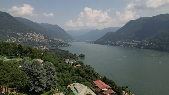 Drone horizontal video of Lake Come in north Italy with the surrounding mountains and boats