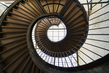 Obraz premium Chonburi, Thailand - May, 26, 2024 : Journey to the Light: The Spiral Staircase at Chonburi, Thailand.