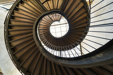 Fototapeta premium Chonburi, Thailand - May, 26, 2024 : Journey to the Light: The Spiral Staircase at Chonburi, Thailand.