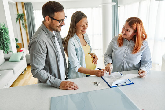 couple house property agent home real estate business buying investment apartment agreement deal client buyer new loan pregnant pregnancy mother sign signing contract maternity belly motherhood