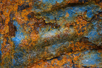 Rusty metal surface with shabby background paint. Blue cracked paint texture on an iron sheet. Fragment of an old metal door, Metal corrosion.
