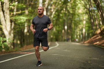 Athletic man running in park