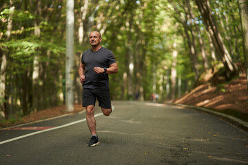 Athletic man running in park