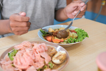 Asian man eating selat solo, javanese food