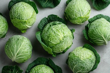 Fototapeta premium Fresh Green Cabbage Heads on Gray Background