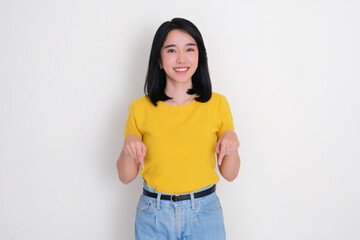 A woman smiling at the camera with both hand pointing below