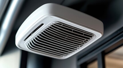 Close-up view of a modern ceiling air conditioner unit with visible grille in a contemporary interior setting.