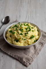 Homemade Chive and Garlic Mashed Potatoes in a Bowl, side view.