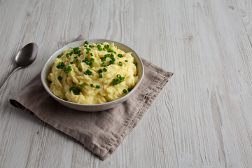 Homemade Chive and Garlic Mashed Potatoes in a Bowl, side view.