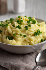 Homemade Chive and Garlic Mashed Potatoes in a Bowl, side view. Close-up.