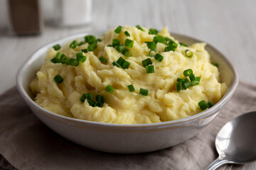Homemade Chive and Garlic Mashed Potatoes in a Bowl, side view.