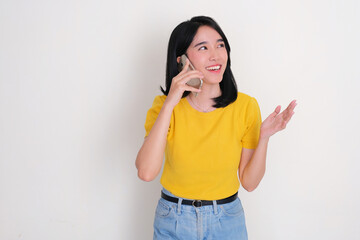 A woman laughing happily when talking on phone